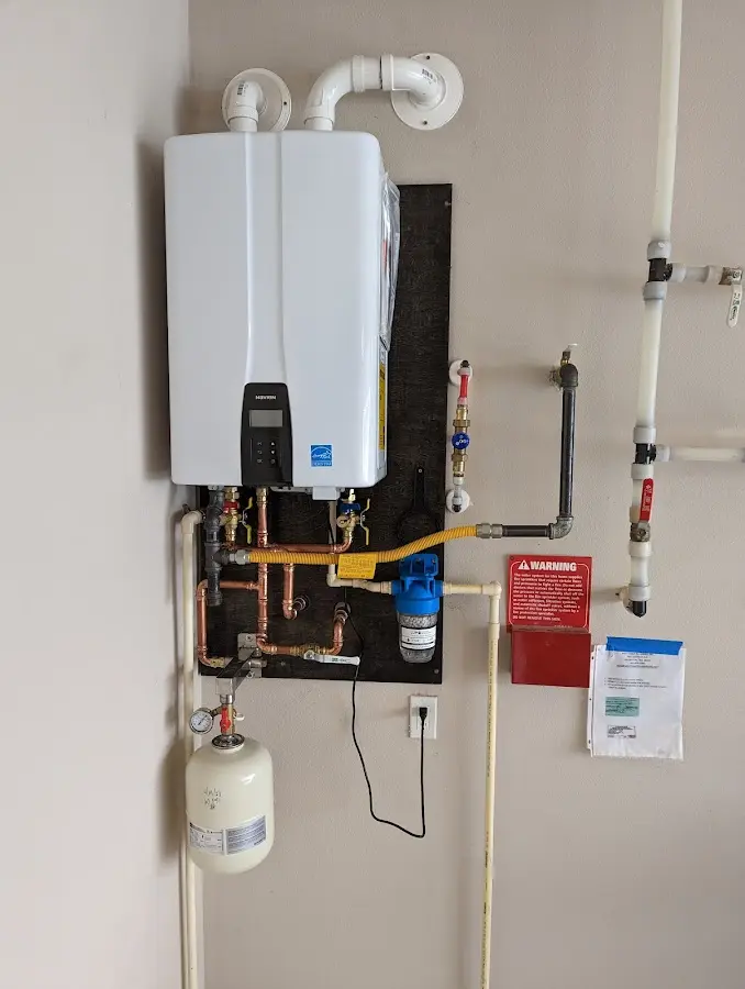 Professional plumber installing copper piping in a Stillwater home